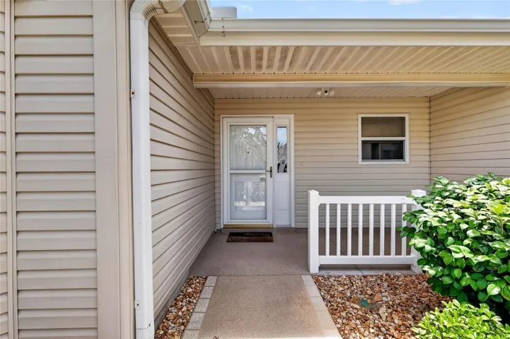 A glass storm door welcomes abundant natural light into the home