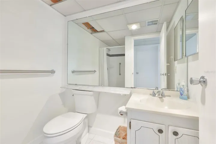 The bathroom is bright and clean with updated toilet and shower.