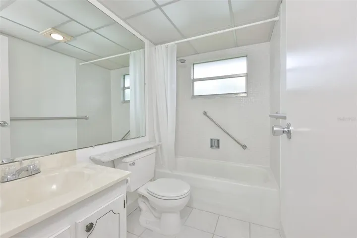 Bright, clean bathroom has had the shower updated and new grab bars added.