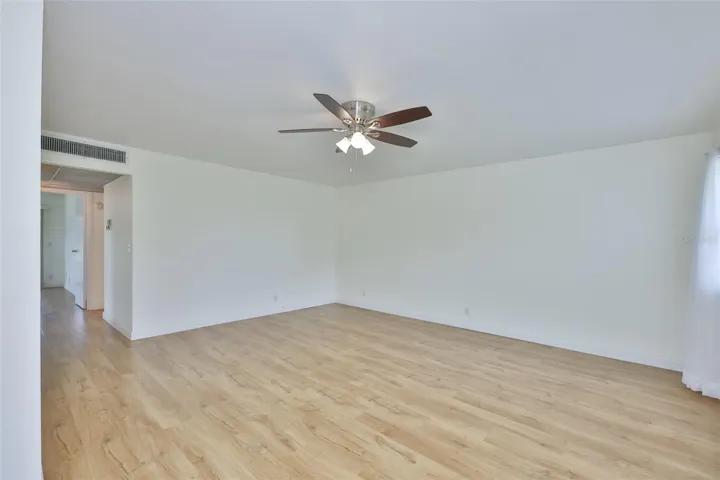 The room is large with lots of wall space for furniture and decor.