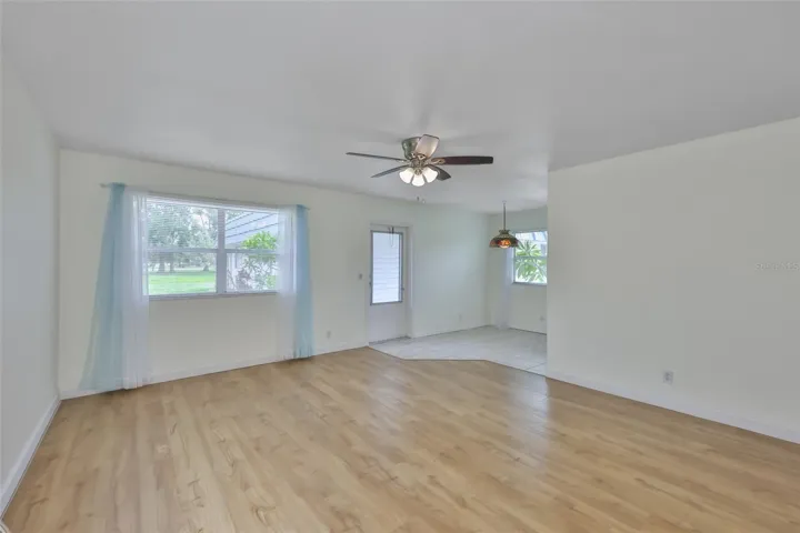 Living room is large with laminate flooring.