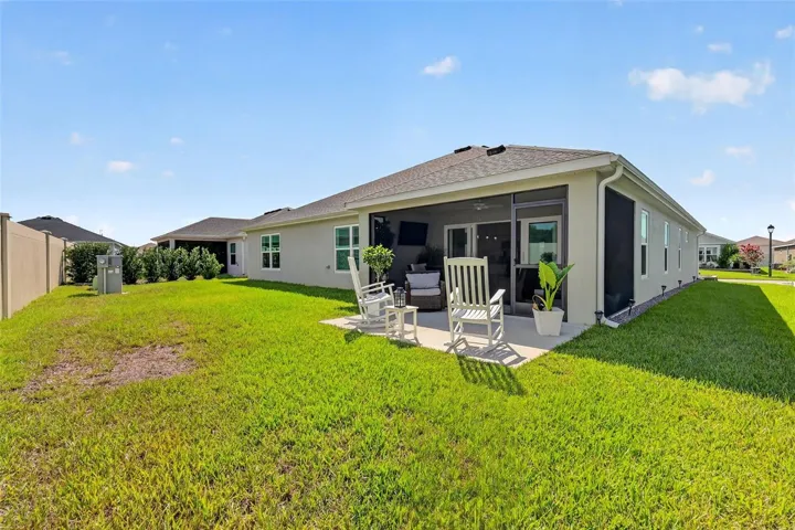 Rear Elevation with Patio, Privacy Wall, and Large Yard with Room For a Pool!