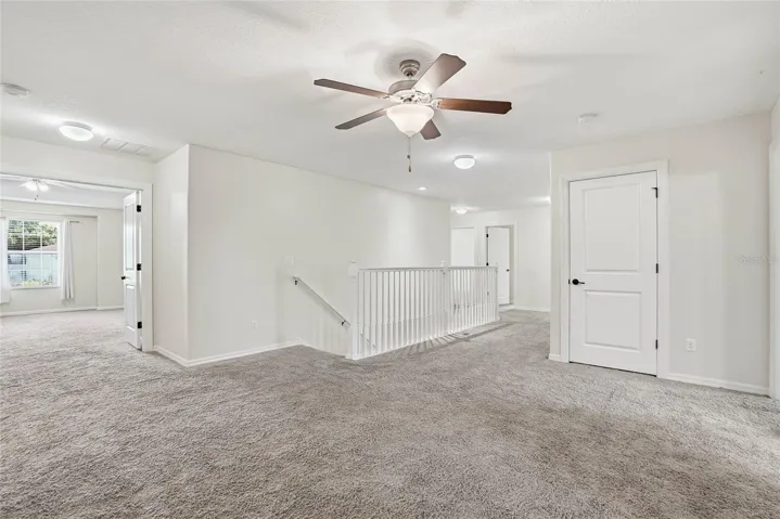 Entrance to the primary suite on the left from the loft space