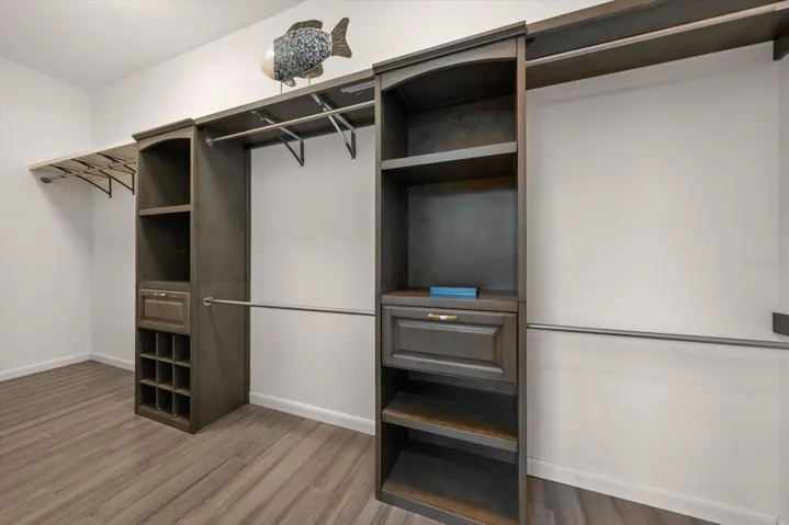 Large walk in customized closet in primary bedroom