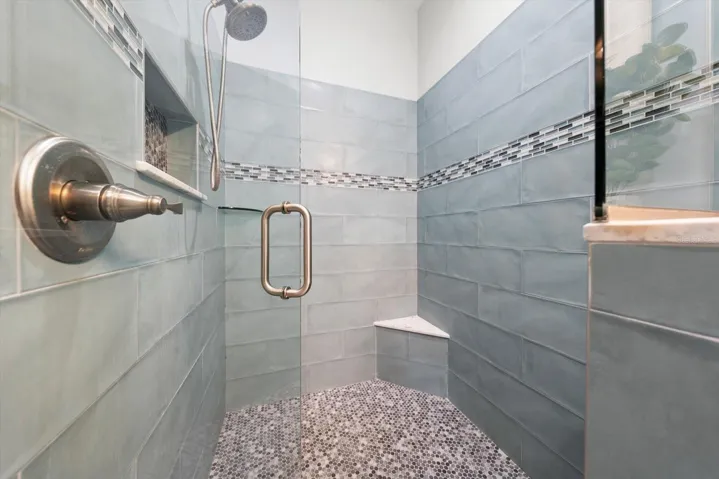 Walk in shower in primary bedroom suite bath area.