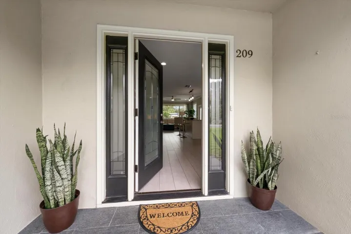 Attractive entry flanked by matching sidelights.