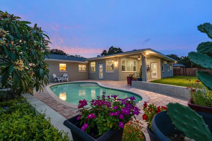 Entirely private, the expansive backyard oasis centers around a sparkling pool.