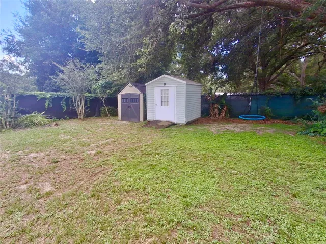 2 sheds in back left of yard