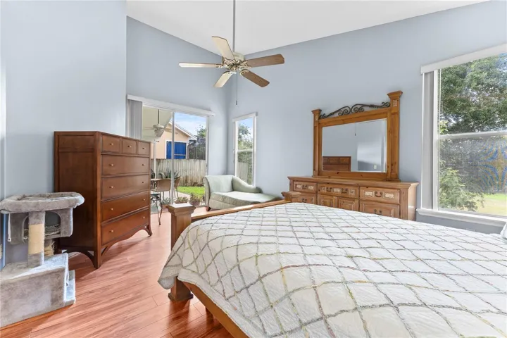 Large primary bedroom with sliding doors to the back patio