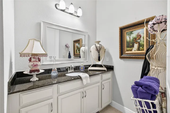 Vanity featuring mirror on the wall on upper level.