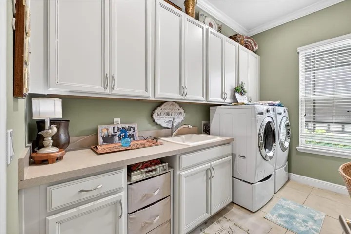 laundry room featuring washer and dryer, sink and cabinates.