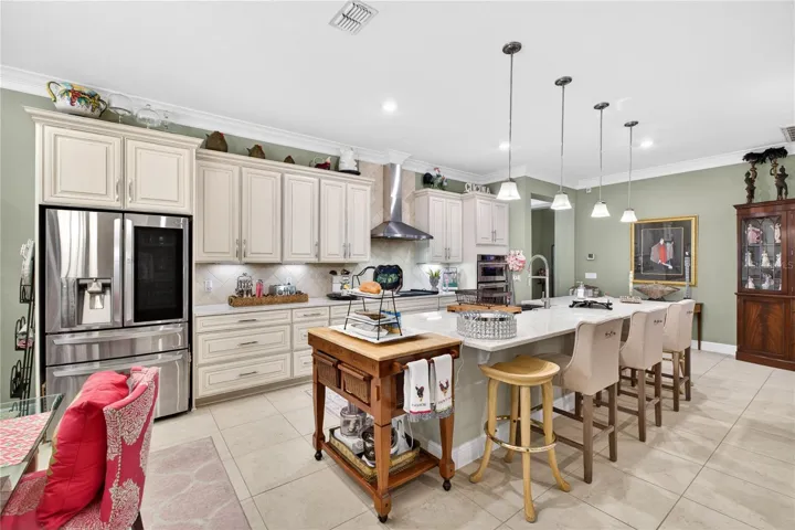 Open-concept designer kitchen featuring stainless steel appliances and a center island.