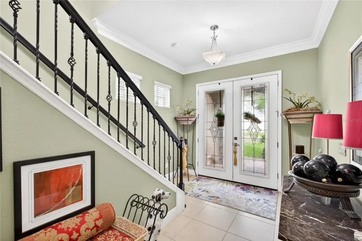 French Door entrance featuring staircase and foye