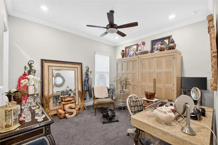 Second bedroom featuring carpeting and crown molding.
