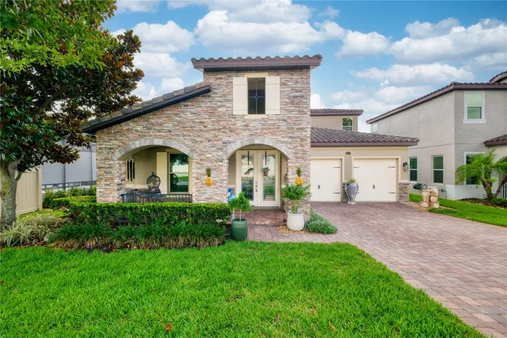 North-facing front elevation featuring a two-car garage and a welcoming front porch.
