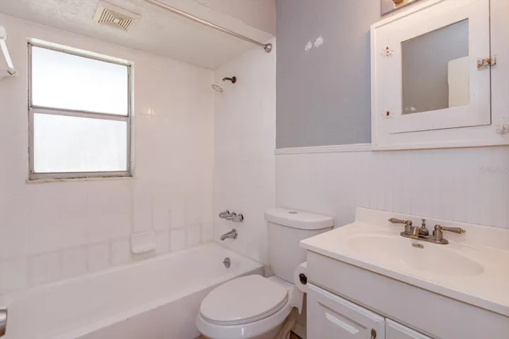 Bathroom #2 Tub and single sink vanity located between bedrooms two and three