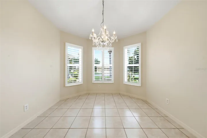 Sunny breakfast nook with plantation shutters, offering a warm and inviting space for morning coffee and casual dining.