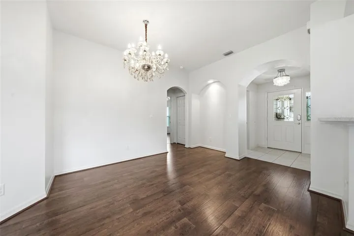 Step through the elegant leaded glass front door into a warm and inviting foyer. The thoughtfully designed floor plan offers direct garage access through the laundry room, with the kitchen conveniently positioned to the left for easy grocery unloading and daily convenience.