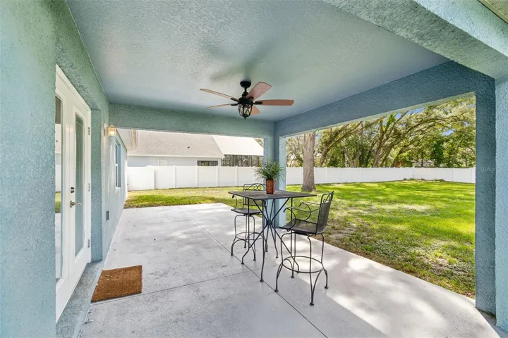 Covered Patio and cleared backyard on extra lot surrounded by privacy fence.