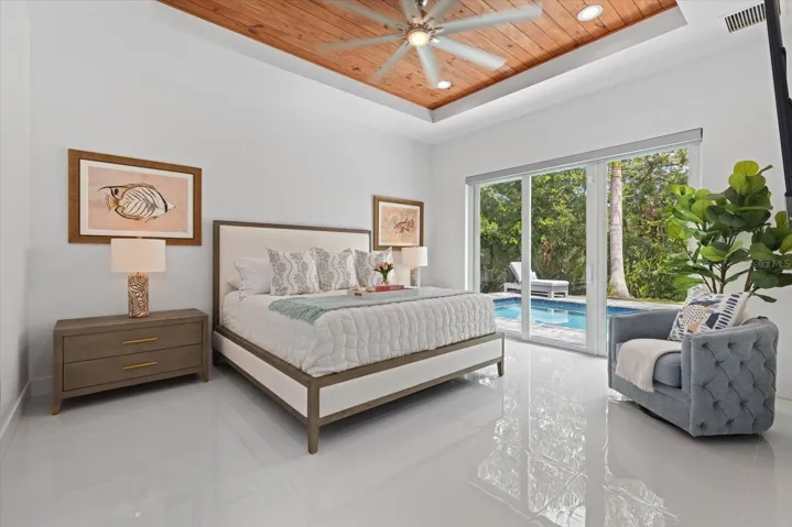 Primary bedroom with sliders to the pool
