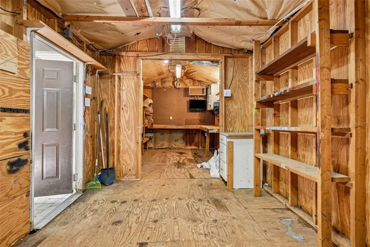 Detached workshop with shelving and A/C