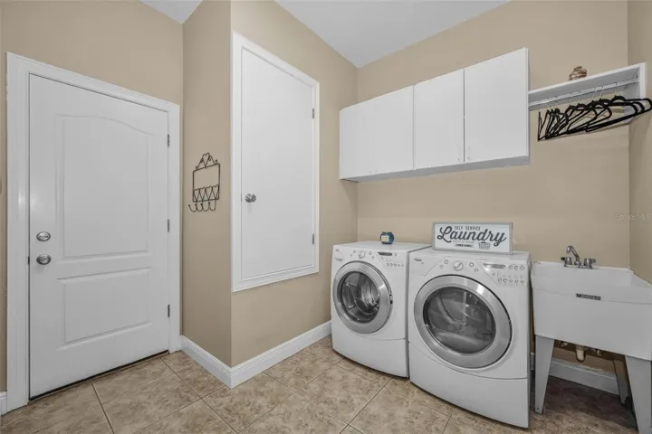 Indoor Laundry Room with Mud Sink and Cabinets