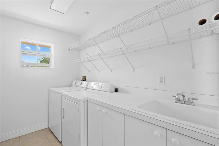 Large laundry room with natural light and sink
