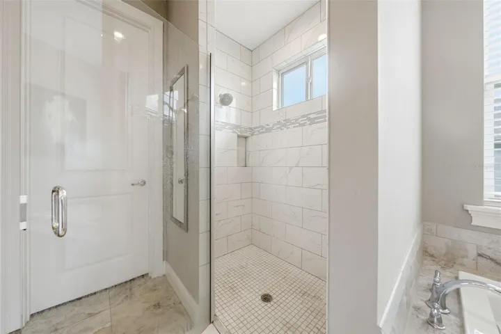 Oversized walk-in shower with dual shower heads