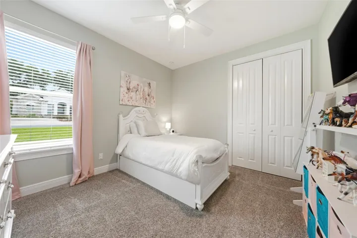 Generously sized bedroom with views of large side yard