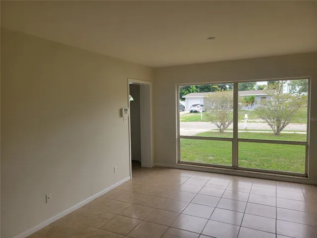 The living room has lots of natural light from the very large front windows.