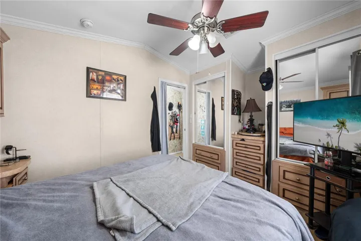 Main Bedroom - Ceiling fan, carpet flooring, built in furniture.