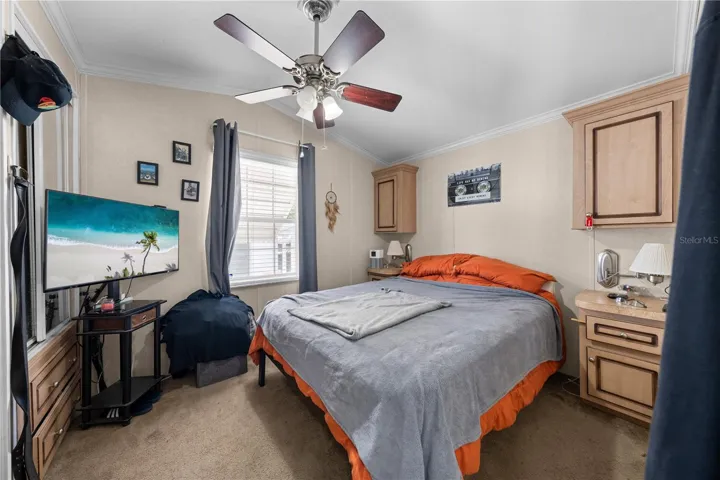 Main Bedroom - Ceiling fan, carpet flooring, built in furniture.