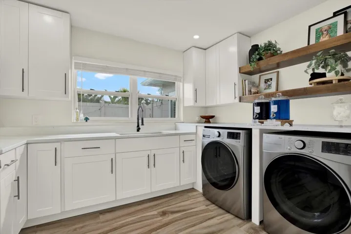 Indoor laundry room with utility sink