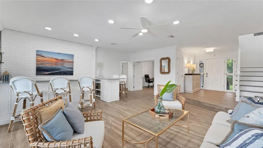View looking back toward entryway from family room and into bonus room/office