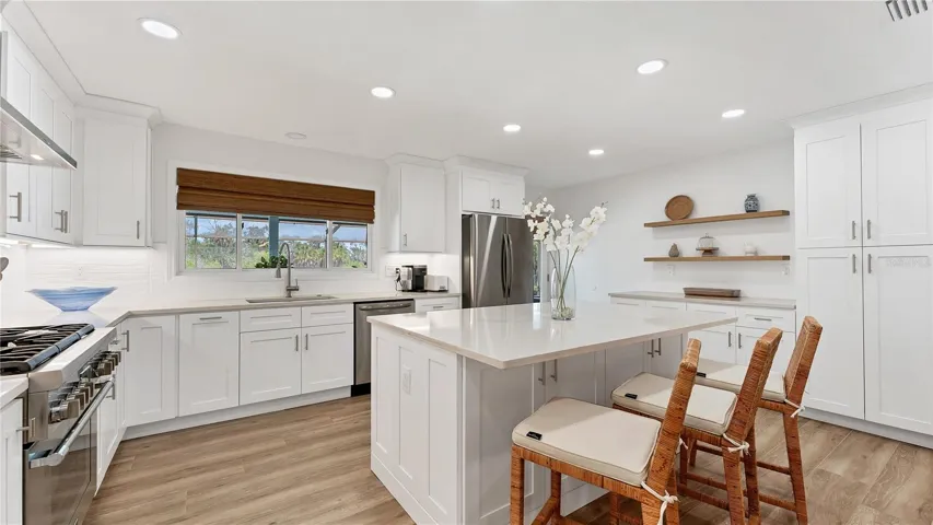 Kitchen view of island and pantry with coffee bar
