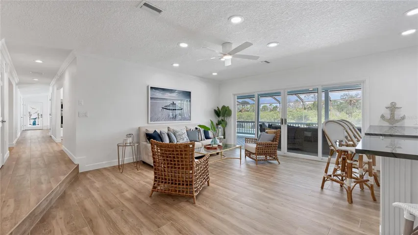 Looking toward hall to kitchen, dining and living room from family room