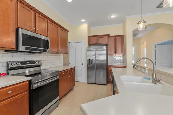 New stainless steel appliances. Hard surface counters and wood cabinets.