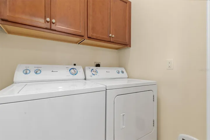Laundry room with storage cabinets.