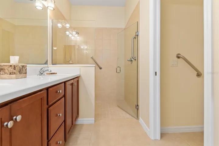 Separate room for commode on right with grab bar.