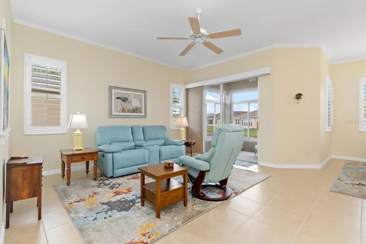 Tasteful decor and Florida color choices. Sofa and chair recline.  Open to sunroom.