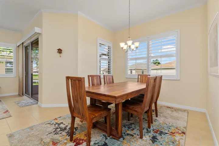 Sizable dining area with beautiful hardwood dining table and chairs. This will convey!