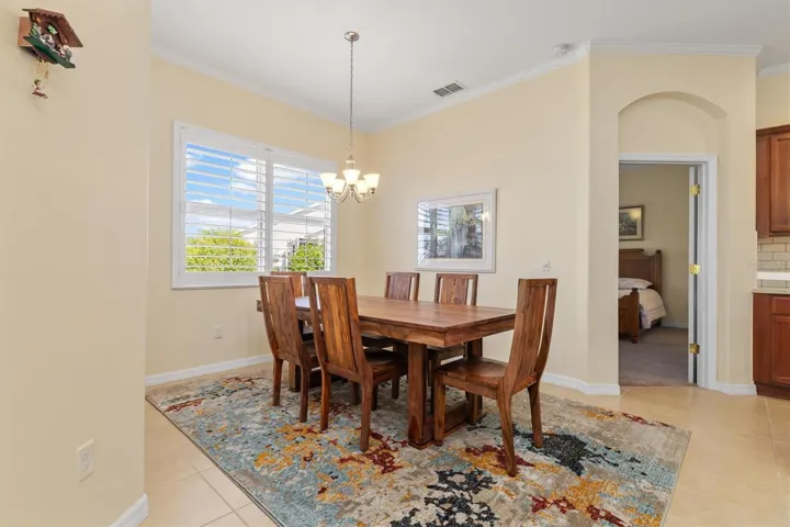 Door to primary bedroom between kitchen and dining.  This is a split plan with guest rooms on other side of villa.