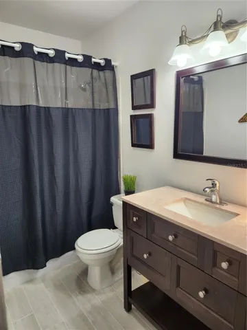 Bathroom wiwth new tile floors and modern fixtures