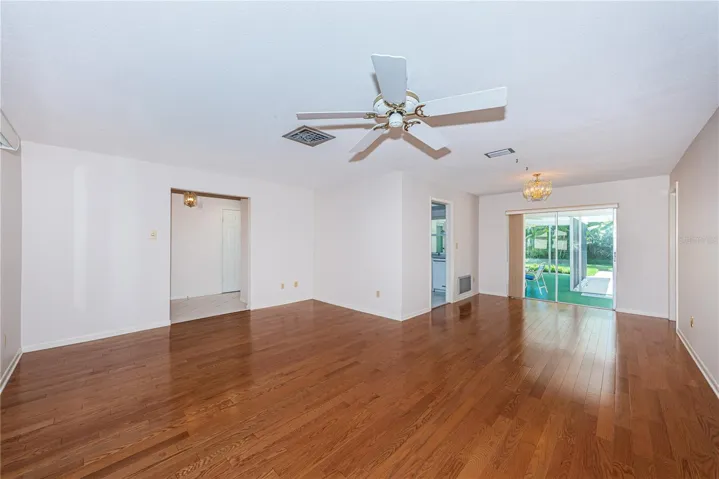 Living room opens up to lanai and pool area
