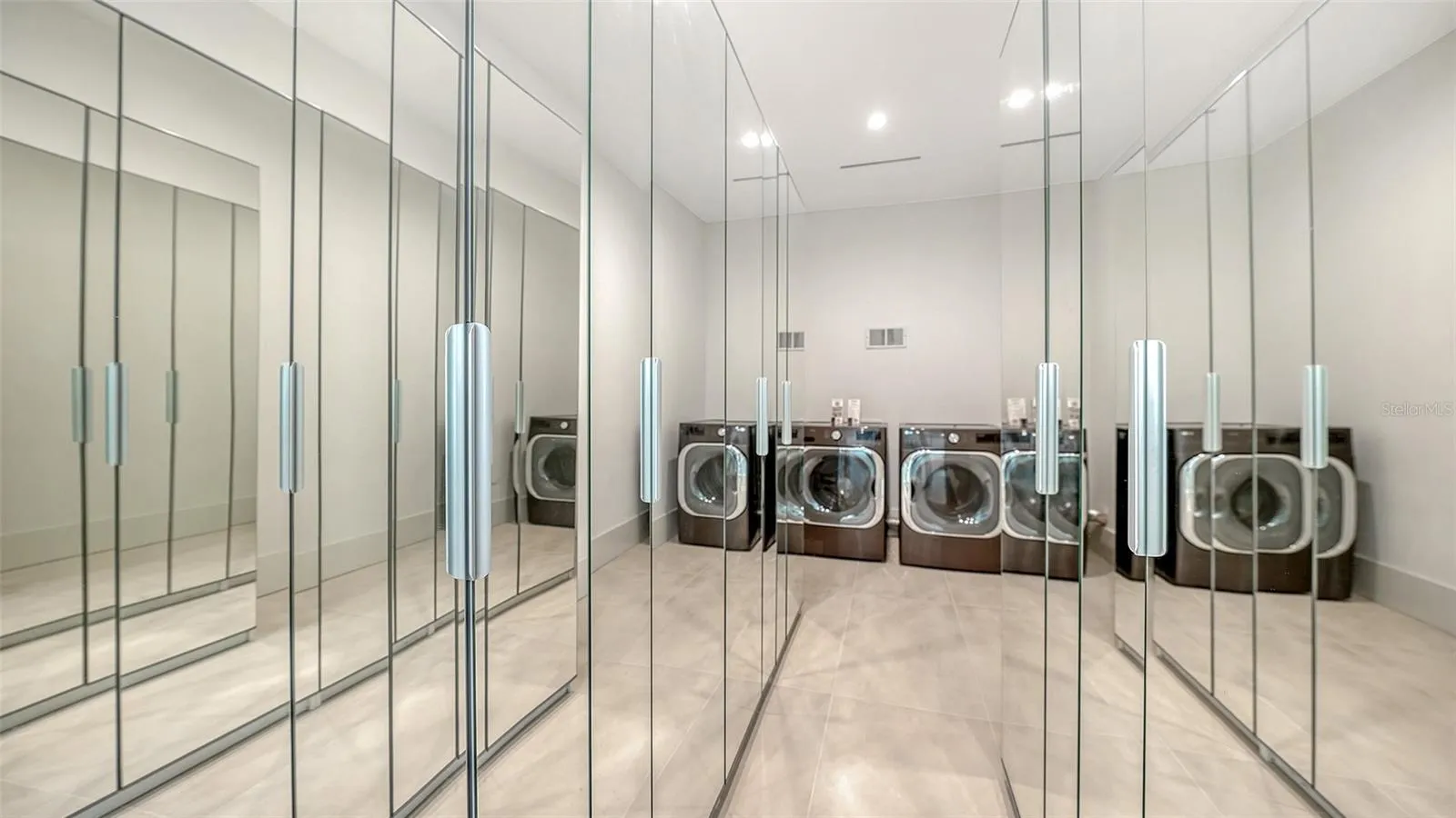 Primary walk-in closet with 2nd washer and dryer