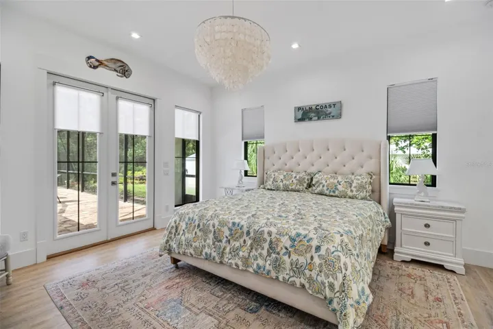 Private owner's retreat featuring elegant French doors that open directly to the pool and outdoor living area.