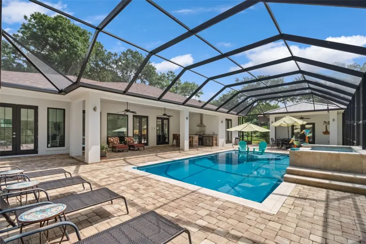 Outside paradise awaits with built in grilling station, refrigerators, sink and storage.