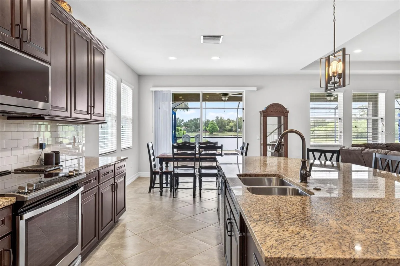 Stainless steel appliances &amp; a view toward the dining area.