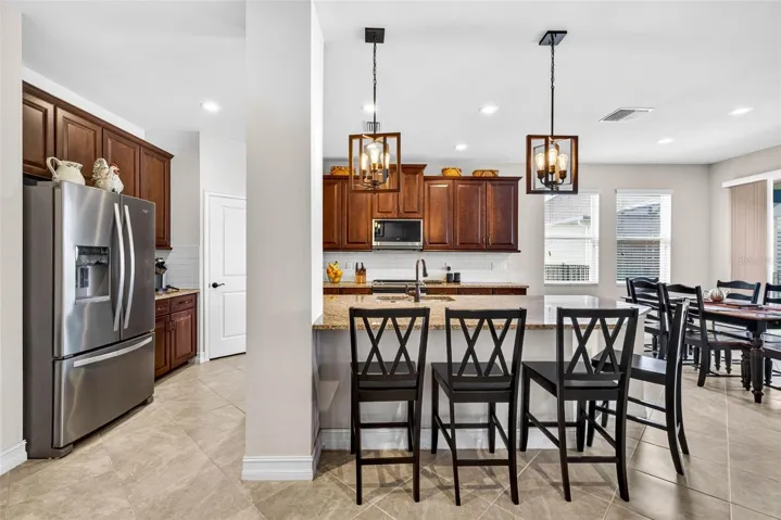 Your kitchen has classic wood cabinetry crowned & overhead light fixtures added.