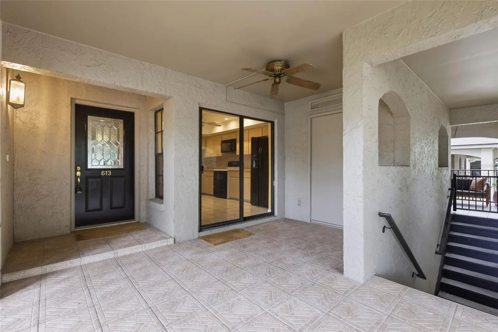 Front porch has space for patio furniture and there is a storage closet to the right.The sliding glass doors lead to the kitchen.